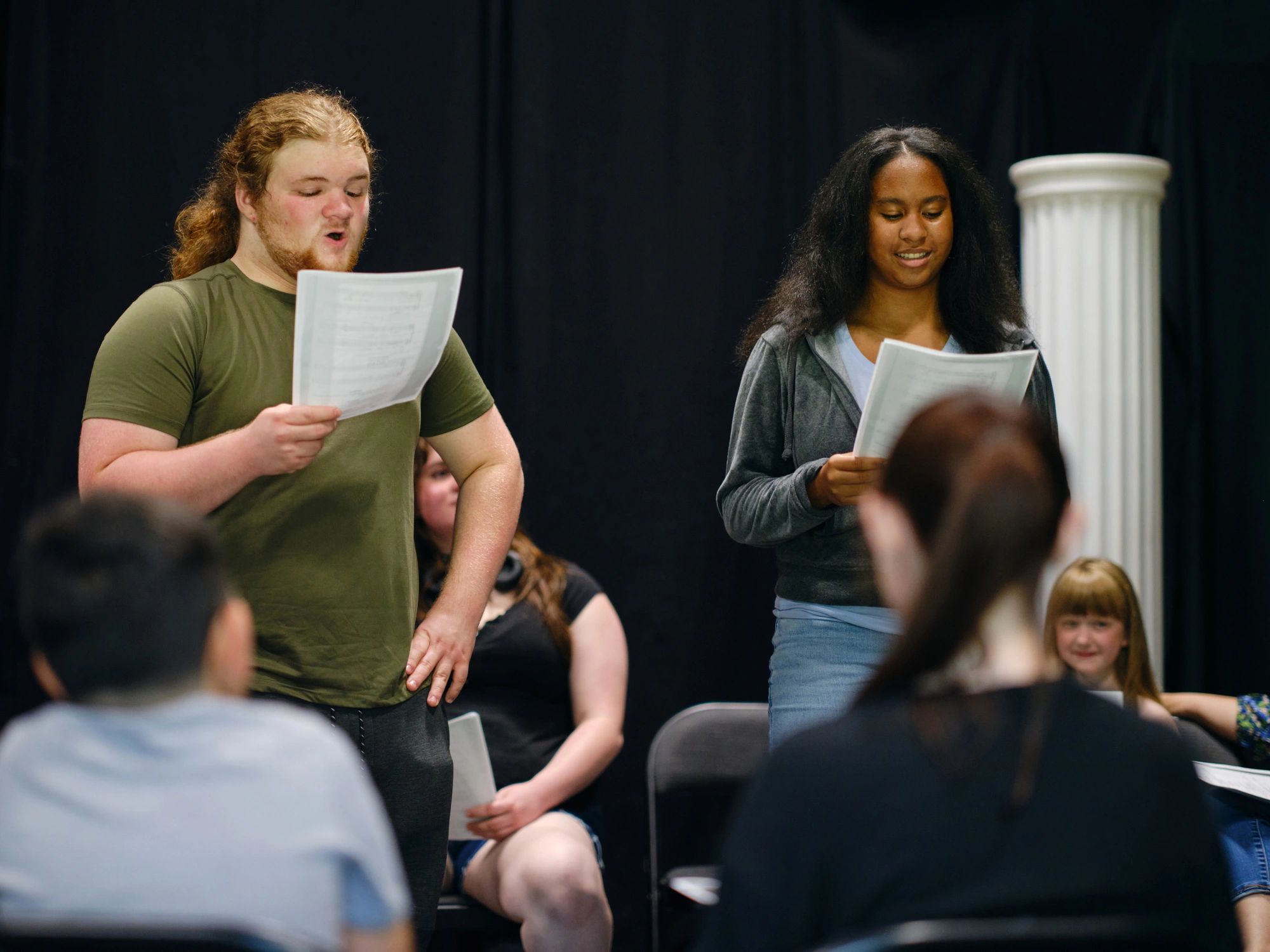 Community theatre group rehearsing a play on stage